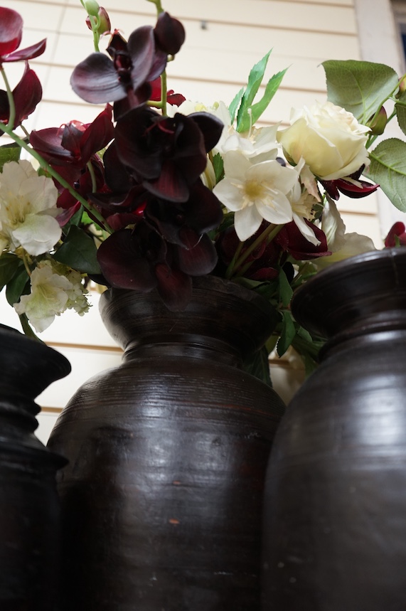 A set of six Nepali turned Himalayan hardwood pots, largest 42cm high. Condition - some breaks and repairs